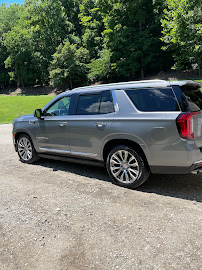 Full-size SUV detailed and parked on a gravel drive