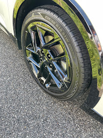 Close-up of a spotless black alloy wheel and tire