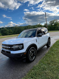 White SUV detailed and parked on a country road